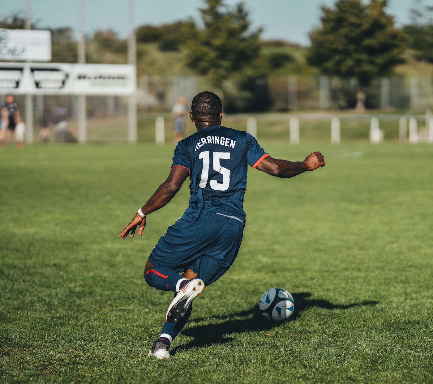 Football player in action on a pitch